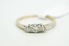 Three stone diamond ring, central old cut diamond with a transitional cut diamond either side,