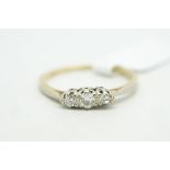 Three stone diamond ring, central old cut diamond with a transitional cut diamond either side,