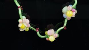 Glass bead necklace, designed as floral clusters, separated by glass tubes