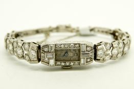 Art Deco diamond cocktail wristwatch, rectangular dial with Arabic numerals, in a diamond set case
