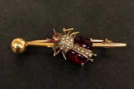 Garnet and pearl bug brooch, on a yellow metal bar brooch, tested as 9ct, measures approximately