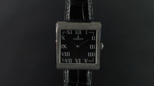 GENTLEMEN'S CORUM BUCKINGHAM WRISTWATCH, square black dial with Roman numerals and silver hands,