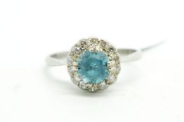 Blue zircon and diamond ring, central blue zircon measuring 6.11mm, surrounded by single cut
