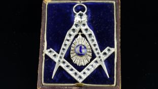 Masonic pendant/badge, set with paste stones and a central 'G' set in a blue glass background