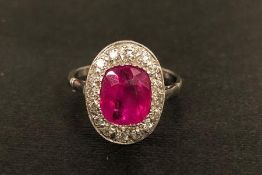 Early 20th century ruby and diamond dress ring, central oval cut ruby surrounded by old cut