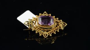 Amethyst brooch, central step cut amethyst in a navette shaped wire and bead work surround,