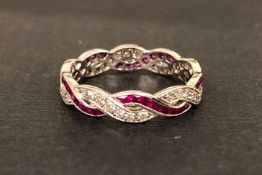 Ruby and diamond twist eternity band, two intertwined rows of round cut diamond and calibre cut