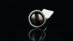 Star sapphire and diamond ring, round cabochon star sapphire weighing 19.60ct, surrounded by round