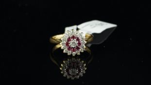 Ruby and diamond cluster ring, central round brilliant cut diamond, surrounded by round cut
