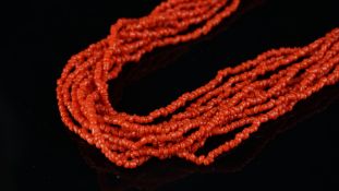 Multi strand coral necklace, ten strands of red coral beads on a gilt clasp