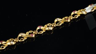 Ruby and diamond snake bracelet, each link in the form of two entwined snakes, with a ruby in one