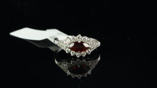Garnet and diamond ring, marquise cut garnet, horizontally set with a border of round brilliant