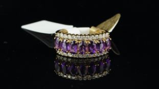 Amethyst and diamond ring, seven oval cut amethysts, set between two rows of diamonds, mounted in