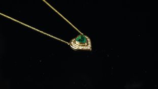 Emerald and diamond heart pendant, central heart shaped emerald surrounded by round brilliant cut