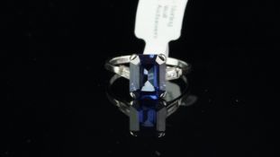 Synthetic sapphire and diamond ring, emerald cut sapphire with baguette cut diamond shoulders, set