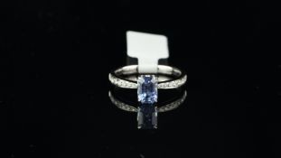 Sapphire and diamond ring, emerald cut sapphire weighing an estimated 1.50ct, with graduated round