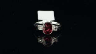 Rubellite and diamond ring, oval cut rubellite with a rose cut diamond set to each side, mounted