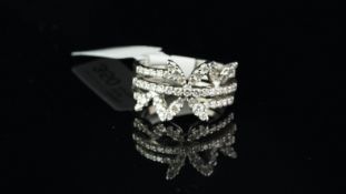 Diamond ring, designed as three diamond rows, in a floral design, mounted in 18ct white gold, ring