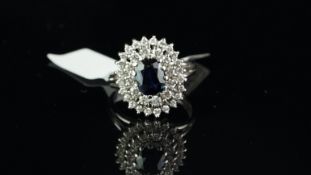 Sapphire and diamond cluster ring central oval cut sapphire measuring approximately 8.3 x 6.14mm,