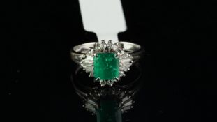 Emerald and diamond ring, step cut emerald weighing an estimated 1.50ct, surrounded by round