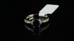 Sapphire and diamond ring, central oval cut sapphire, with three round brilliant cut diamonds each