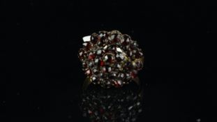 A Georgian garnet cluster ring, set in yellow metal tested as 9ct, ring size S