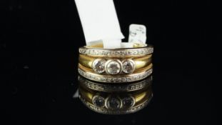 Diamond ring, central row of three rubover set round brilliant cut diamonds, with a row of pave