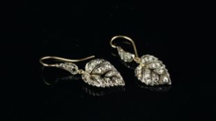 Pair of rose cut diamond set leaf earrings, on a French wire fitting, one leaf is larger than the