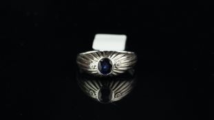 Gentlemen's sapphire and cubic zirconia ring, central rubover set sapphire with a round brilliant
