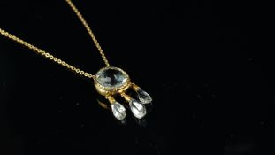 Topaz pendant, circular cut blue topaz, with three further drops, mounted in yellow metal stamped