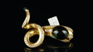 A snake brooch, large oval cabochon cut green tourmaline set to the head, measuring approximately