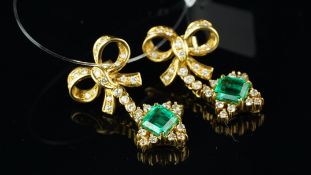 A pair of emerald and diamond drop earrings, designed as a diamond set bow, suspending an emerald
