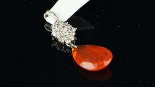 A fire opal and diamond pendant, with a briolette cut fire opal drop, suspended from an oval cluster