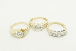 Three cubic zirconia rings, one set in 9ct yellow gold and two set in 14ct yellow gold