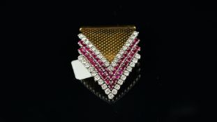 Ruby and diamond clip, arrow head design, with round brilliant cut diamonds and round faceted