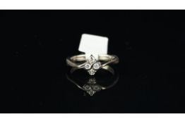 Four stone diamond cluster ring, four round brilliant cut diamonds set in a diamond shape, with