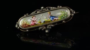 Antique brooch, painted enamel panel depicting cherubs playing with floral detail, mounted in a