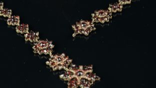 Georgian garnet necklace, designed as twelve garnet clusters, with five larger star clusters at