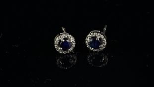 Sapphire and diamond cluster earrings, target design with a central round cut sapphire, surrounded