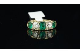 Antique emerald and diamond carved half hoop ring, two old cut diamonds set in between three