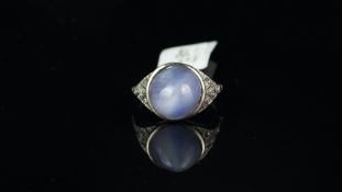 Star sapphire and diamond ring, central round cabochon cut star sapphire, with diamond set