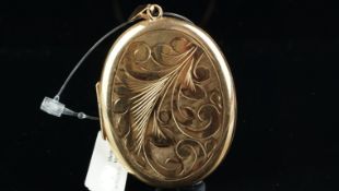 A vintage 9ct gold oval locket, with carved detail to the front of the locket, hallmarked Birmingham