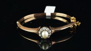 A late Victorian gold pearl and diamond bangle, set with a semi baroque pearl, with an old-cut
