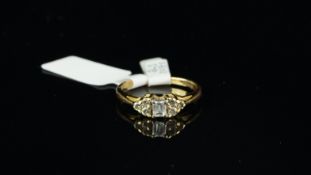Diamond ring, central baguette cut diamond, with three round brilliant cut diamonds set each side,