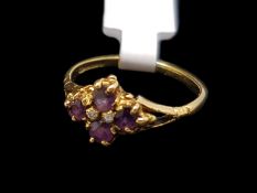An amethyst dress ring, four round cut amethysts, in 18ct yellow gold, ring size L