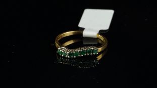 Emerald half eternity ring, round cut emeralds, claw set in a wave design, mounted in yellow metal