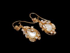Pair of mother of pearl and white stone drop earrings, mounted in rose metal stamped 21ct