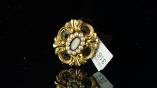 Historical interest: Pearl and enamel memorial brooch, central locket compartment containing a