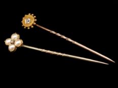 Two stick pins, one pearl and diamond cluster pin, together with a single stone old cut diamond pin