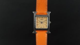 LADIES' HERMES WRISTWATCH, square salmon dial with silver Arabic and baton hour markers in a 19mm